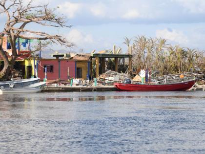 Boats are seen along the banks of the Black River in St Elizabeth on November 20, 2025. Hurricane Melissa, which hit Jamaica on October 28 has disrupted river tours and other business activity.