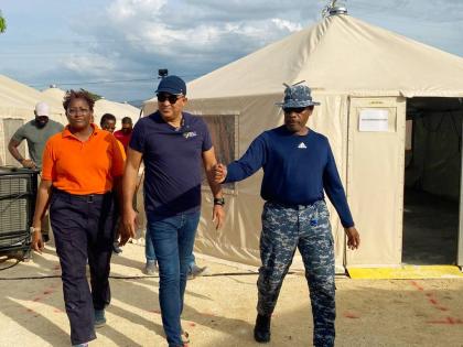 Minister of Health and Wellness, Dr Christopher Tufton (centre), is guided on a tour of the Barbados Field Hospital in Westmoreland by Barbados Defence Force Emergency Medical Team (EMT) Leader, Lieutenant Commander Anderson Goodridge, and Clinical Medical