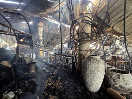 The charred interior of a nightclub, which caught fire early Sunday, is seen in Arpora, in Goa, India.