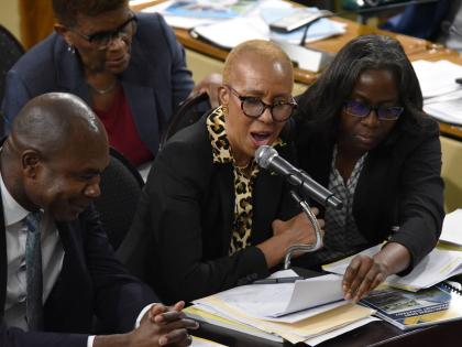 Fayval Williams (centre), minister of the finance and the public Service, answers questions during yesterday’s sitting of the Standing Finance Committee of Parliament as Financial Secretary Darlene Morrison and Zavia Mayne, state minister in the finance 