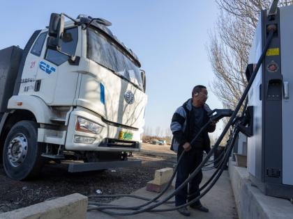 
A driver charges his electric truck at a charging station on the outskirts of Beijing, on November 14, 2025.