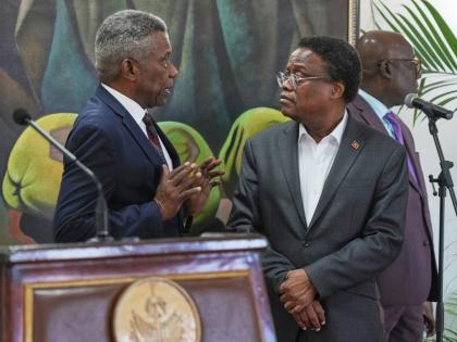 Chief of Protocol of the National Palace Marc Marie Yves Mazile speaks to Fritz Alphonse Jean, a member of Haiti’s transitional presidential council, before the start of a press conference in Port-au-Prince, Haiti, Tuesday, November 25, 2025.