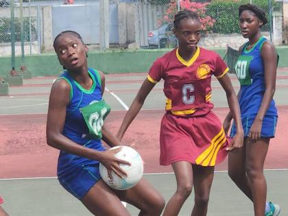 Action in the junior ISSA Urban Netball Competition final at thee St Andrew’s High School for Girls yesterday.