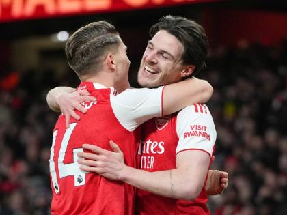 Arsenal's Viktor Gyoekeres and Arsenal's Declan Rice celebrate after Brighton's Georginio Rutter scored an own goal during the English Premier League football match between Arsenal and Brighton and Hove Albion in London on December 27, 2025. 