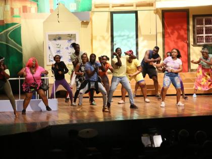 Skillet, (in yellow T-shirt), played by Calneth Reid, suggests that a Round Robin could provide the money to save the Big Yard. The 84th season of pantomime, Big Yaad Vibes, opened on Boxing Day at the Little Theatre, in Kingston.