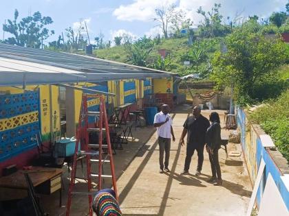 Senator Marlon Morgan (centre), parliamentary secretary in the Ministry of Education, Skills, Youth and Information; Susan Nelson Smith (right), regional director at the ministry for Region Five; and Dameon Sinclair, managing director at the Southern Contr