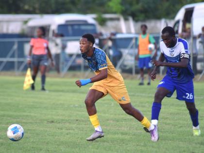 
Racing United’s Kadean Young (left) runs away from Mount Pleasant Academy’s Clifford Thomas during their Jamaica Premier League game at the Drax Hall Sports Complex on January 11.