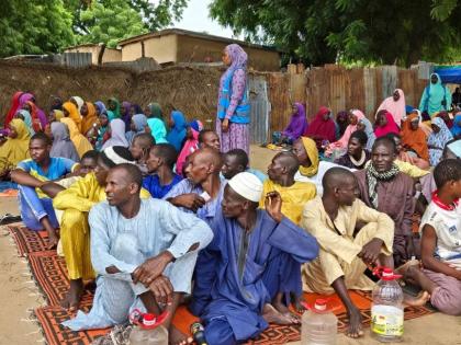 People wait to receive food donations from the United Nations World Food Program in Damasak, northeastern Nigeria, October 6, 2024. 
