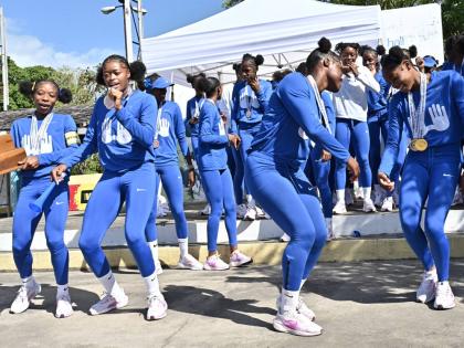 Hydel High School athletes celebrate winning the ISSA/GraceKennedy Boys and Girls’ Athletics Championships girls’ title at the school in March of 2025. 
