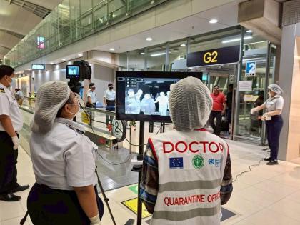 In this photograph provided by the public relations department of the Suvarnabhumi International Airport, Quarantine doctors watch thermal scanning of travellers from west Bengal, India at the Suvarnabhumi International Airport in Samut Prakarn, Thailand, 