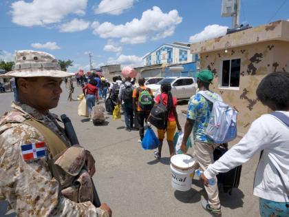Dominican Republic security forces stand guard on a border bridge between Dajabón, Dominican Republic, and Haiti, Thursday, September 14, 2023. (AP Photo/Ricardo Hernández)