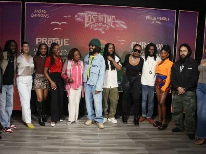 Some of the artistes who will be performing at the Lost in Time Festival on February 28 and March 1 get their photo ops with Entertainment Minister Olivia Grange (sixth from left) and sponsors during the launch on Thursday at the AC Hotel Kingston.