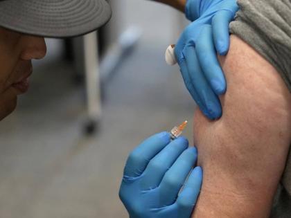  Matt Caldwell, left, a Lubbock Fire Department official, administers a measles, mumps and rubella vaccine to Clair May at the Lubbock Health Department, February 26, 2025, in Lubbock, Texas.