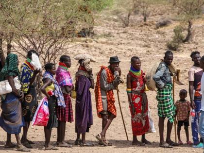 Locals queue to receive relief food as severe drought continues, in Lomekulu Village, Turkana County, Kenya, Sunday, February 8, 2026. 