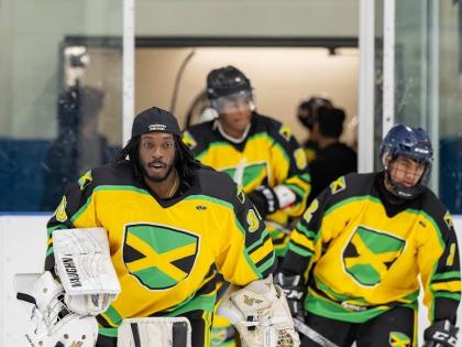 Giovani Smith leads Jamaica’s ice hockey team out onto the rink during a Challenger series game.