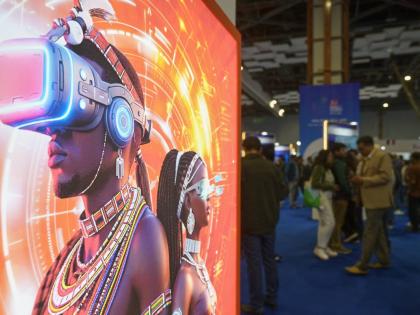 
Visitors stand next to an advertising billboard at AI summit in New Delhi, India.