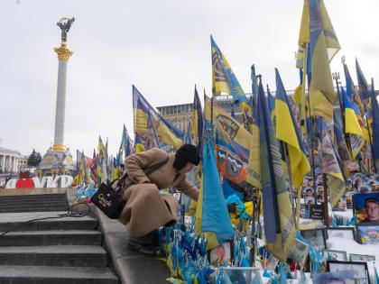A woman places flowers at the memorial to the fallen Ukrainian soldiers on Independence Square to mark the fourth anniversary of Russia’s full-scale invasion in Kyiv, Ukraine, on Tuesday, February 24.