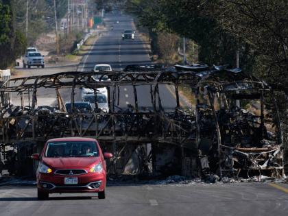 Vehicles drive past a charred bus the day after the Mexican army killed Jalisco New Generation Cartel leader Nemesio Oseguera Cervantes, known as ‘El Mencho’, in Guadalajara, Mexico, on Monday, February 23.
