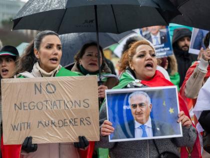 Iranian protesters hold placards and portraits as they demonstrate in front of United Nations office ahead of indirect nuclear talks between the United States and Iran in Geneva, Switzerland, on Tuesday, February 17.