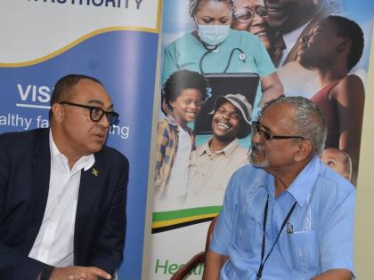 Minister of Health and Wellness Dr Christopher Tufton (left) and clinical coordinator, Western Regional Health Authority, Dr Delroy Fray, converse during a press briefing at the WRHA offices in Montego Freeport on Thursday. 