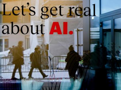 People reflected in a window of a hotel at the Davos Promenade with a slogan about AI alongside the World Economic Forum in Davos, Switzerland in January 2024. 