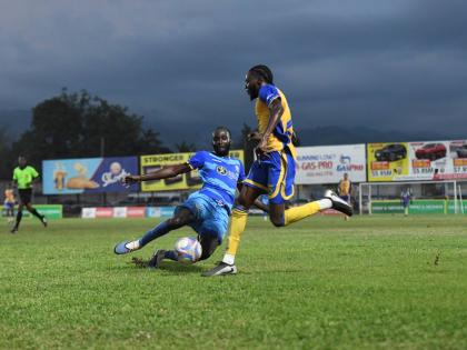 Molyes United’s Nicache Murray (left) goes in for a tackle aainst Harbour View’s Darnel Edwards during their Jamaica Premier League football match at the Waterhouse Mini Stadium yesterday.  The game ended 2-2.