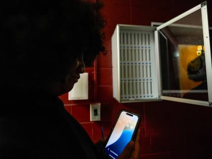 A student views her cell phone at Ronald McNair Sr High School in August 2025 in Atlanta. 