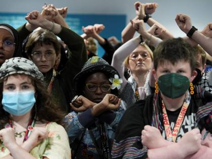 Activists demonstrate in silence, protesting a draft of a proposed deal for curbing climate change at the COP29 UN Climate Summit, Friday, November 22, 2024, in Baku, Azerbaijan. 