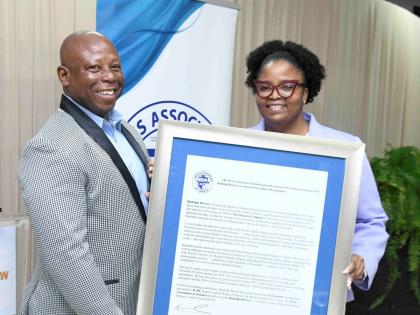 The Gleaner’s Rudolph Brown is presented with a citation in recognition of his 37 years of service to photojournalism at the Press Association of Jamaica’s veteran luncheon held on March 4, 2026 at J. Wray and Nephew’s office, Dominica Drive, New Kin