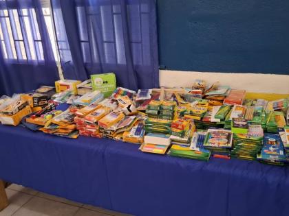 Tables neatly arranged with donated school supplies that were prepared for distribution to students affected by Hurricane Melissa at Maud McLeod.