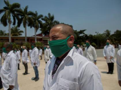 Cuban doctors form up during a farewell ceremony as they get ready to leave Havana to bring their expertise to foreign lands. 