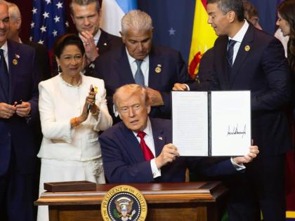 United States President Donald Trump is joined by Trinidad and Tobago Prime Minister Kamla Persad-Bissessar at the signing ceremony for the agreementt establishing the military alliance known as the Americas Counter-Cartel Coalition.