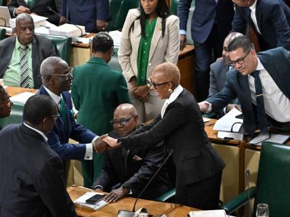 Government members of the House of Representatives congratulate Fayval Williams, minister of finance and the public service, after she opened the 2026-2027 Budget Debate at Gordon House yesterday.