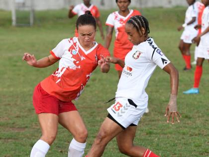 UWI Women’s Caitlyn Sams (left) tries to evade the attentions of Arnett Gardens’ Tuanashe Hamilton during a Jamaica Women’s Premier League football at the UWI Mona Bowl yesterday. Arnett won 3-0.