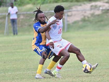 Orel Miller of Portmore United shields the ball from Harbour View’s Kenly Deacon during yesterday’s Jamaica Premier League match at the Ferdi Neita Park. Portmore won 4-2. 