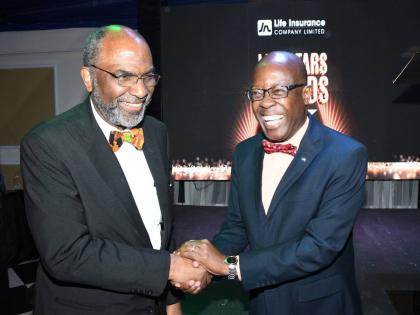 Earl Jarrett (left), chief executive officer of the JN Group, shares a light moment with Hugh Reid, managing director of JN Life Insurance Company, at the company’s ‘Life Stars’ staff awards for 2025, held at the Terra Nova All-Suite Hotel in Kingsto