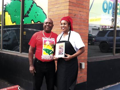 Ed and Lily Pottinger with their book outside The Real Jerk restaurant in 2013.