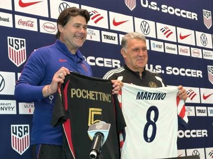 United States coach Mauricio Pochettino (left) and Atlanta United coach Tara Martino pose with jerseys during a news conference before the men’s national  team training yesterday in Marietta, Georgia.