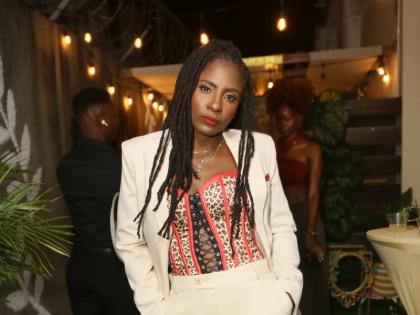 Jah9 makes an off-stage statement at her ‘The Open Heart Project’ listening event, pairing tailored trousers and a structured jacket with a sultry bustier and striking red mules.