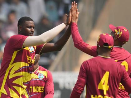 West Indies’ Jason Holder (second left) and teammates celebrate the dismissal of Nepal’s Aarif Sheikh during the ICC T20 World Cup cricket match in Mumbai, India on February 15.