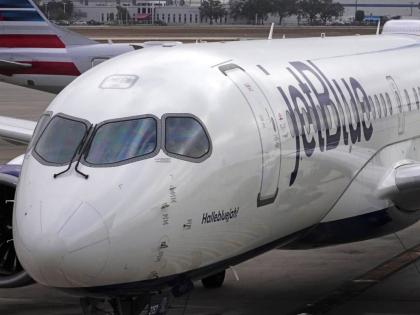 A Jet Blue Airlines jet pushes back from a gate at the Pittsburgh International Airport in Imperial, Pa., February 13, 2026. (AP Photo/Gene J. Puskar, File)