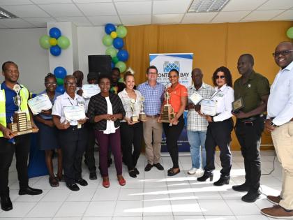 Gloria Henry (fourth left) and Mark Hart (centre) during the presentation of the Montego Bay Free Zone Employment Creation Awards at the Montego Bay Free Zone, operated by the Port Authority of Jamaica.