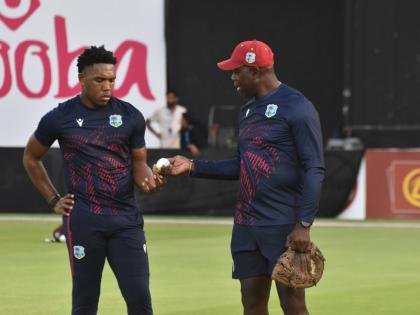 West Indies fast bowling consultant Ottis Gibson (right) gives instruction to fast bowler Jediah Blades during a series against Nepal in Sharjah in September 2025.