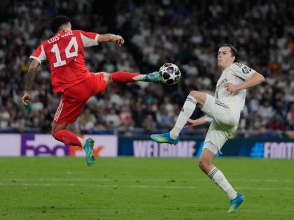 Real Madrid’s Alvaro Carreras (right) and Bayern Munich’s Luis Diaz challenge for the ball during the Champions League quarter-final first-leg football match in Madrid, Spain, yesterday.