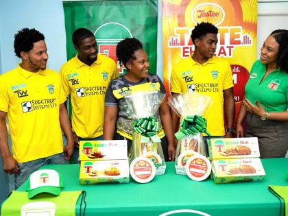 Korie-Page Jones (right), promotions & execution manager at Continental Baking Company Limited, is pictured with members of Waterhouse Football Club (from left): Mario Simms, Colorado Murray, Jodian James, and captain Kymani Campbell, during the handover o