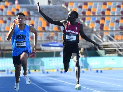 Gout Gout (right) waves while winning the junior 100 metres at the Australian Athletics Junior Championship in Brisbane on Saturday.
