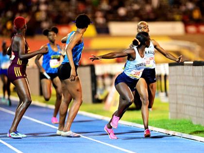 Edwin Allen (right) making the final baton exchange on the 4x400m open girls relay final ahead of Hydel High (centre) and Holmwood Technical at the ISSA GraceKennedy Boys’ and Girls’ Athletics Championships at the National Stadium in St Andrew, Jamaica