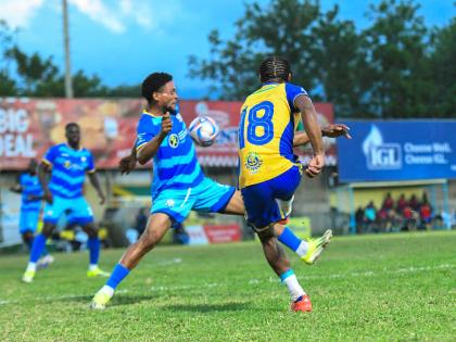 
Harbour View’s Raje Ximines (right) kicks the ball as Odane Murray of Molynes United reacts during the Jamaica Premier League football match at Waterhouse Stadium on March 6. With three games to go in the preliminary round, both teams are locked in a ba