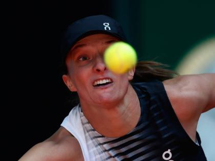 Iga Swiatek of Poland returns the ball to Ann Li of the US during the Madrid Open tennis tournament in Madrid yesterday.