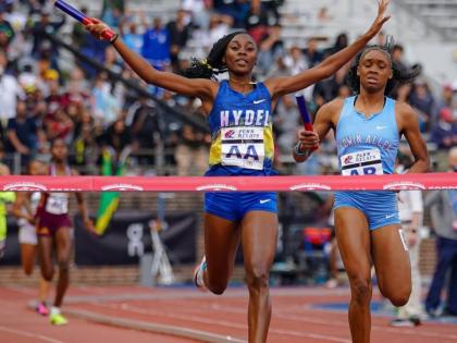 Hydel High School’s Nastassia Fletcher raises her arms as she crosses the finish line to win the Championship of America 4x400 metres at the Penn Relays inside Franklin Field Stadium in Pennsylvania on Friday. Edwin Allen’s Marria Crossfield finishes s